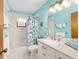 Fresh blue bathroom featuring a tub and shower, along with a bright vanity, for a relaxing experience at 16405 Se 90Th Ct, Summerfield, FL 34491