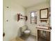 A small, vintage-style bathroom with a green toilet, sink, and accessories at 16405 Se 90Th Ct, Summerfield, FL 34491