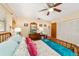 Inviting bedroom with wood furnishings, ceiling fan, and a large closet, creating a peaceful sanctuary at 16405 Se 90Th Ct, Summerfield, FL 34491