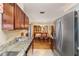 An open kitchen with stainless steel appliances, granite countertops, and a dining area, ideal for Gathering meals at 16405 Se 90Th Ct, Summerfield, FL 34491