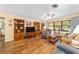 Inviting living room features hardwood floors, large windows, and comfortable seating at 16405 Se 90Th Ct, Summerfield, FL 34491