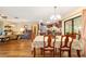Spacious living area with hardwood floors, a dining table with 6 chairs, and a comfortable seating area at 16405 Se 90Th Ct, Summerfield, FL 34491