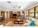 Comfortable living room boasting hardwood floors, built-in shelving, and lots of natural light at 16405 Se 90Th Ct, Summerfield, FL 34491