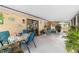Enclosed patio featuring an outdoor dining space and seating with garden accents and lighting at 16405 Se 90Th Ct, Summerfield, FL 34491