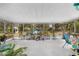 Enclosed patio features open-air design with a gazebo, above-ground pool, and garden views at 16405 Se 90Th Ct, Summerfield, FL 34491