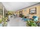 Enclosed patio featuring outdoor seating, potted plants, and backyard views at 16405 Se 90Th Ct, Summerfield, FL 34491