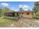 An exterior view showcases the house with a screened in porch at 16405 Se 90Th Ct, Summerfield, FL 34491