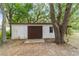 A wide, exterior view of the shed with a closed barn-style door at 16405 Se 90Th Ct, Summerfield, FL 34491
