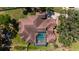 Aerial view showcasing the intricate terracotta roof design and screened-in pool of the beautiful home at 1718 Sw 27Th St, Ocala, FL 34471