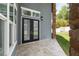 Covered back patio showing travertine flooring, French doors to home, and view to the backyard at 1718 Sw 27Th St, Ocala, FL 34471