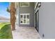 Covered back patio with travertine flooring, stone pillars, and access to multiple rooms in the home at 1718 Sw 27Th St, Ocala, FL 34471