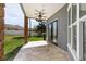 The covered back patio features stone pillars, travertine flooring, and access to the home through glass doors at 1718 Sw 27Th St, Ocala, FL 34471