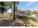 The backyard features a home with solar panels and a play set in an expansive yard at 1718 Sw 27Th St, Ocala, FL 34471