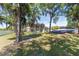Lush backyard view with a play set, solar panels, and a glimpse of the home at 1718 Sw 27Th St, Ocala, FL 34471