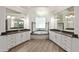 Bright bathroom featuring dual vanities and a garden tub under a window at 1718 Sw 27Th St, Ocala, FL 34471