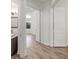 Hallway leading to bath with gray vanity, mirror, and door to bedroom with tray ceiling at 1718 Sw 27Th St, Ocala, FL 34471