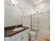 Bathroom featuring a granite countertop vanity, toilet, and shower over tub with sliding glass doors at 1718 Sw 27Th St, Ocala, FL 34471