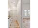 Bathroom featuring a vanity, toilet, and shower over tub, leading into a room with tiled flooring and arched windows at 1718 Sw 27Th St, Ocala, FL 34471