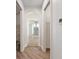 Hallway view leading to bathroom with glass shower, offering privacy and functionality at 1718 Sw 27Th St, Ocala, FL 34471