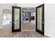 View through ornate glass double doors to a sitting room with a fireplace at 1718 Sw 27Th St, Ocala, FL 34471