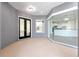 Covered entrance with black framed glass doors and kitchen view through floor-to-ceiling windows at 1718 Sw 27Th St, Ocala, FL 34471