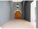 Inviting foyer featuring unique wooden doors, textured walls, and a stylish hanging light fixture at 1718 Sw 27Th St, Ocala, FL 34471