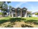 Exterior rear elevation view of home featuring covered patios, manicured lawn, and multi-level architecture at 1718 Sw 27Th St, Ocala, FL 34471