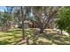 Beautiful home with lush landscaping, mature trees, brick accents, and a circular driveway at 1718 Sw 27Th St, Ocala, FL 34471