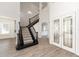 Inviting foyer with grand staircase and decorative glass entry doors at 1718 Sw 27Th St, Ocala, FL 34471
