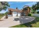 Home featuring a three car garage, stone accents, and a large circular driveway at 1718 Sw 27Th St, Ocala, FL 34471