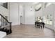 Open-concept living room with soaring ceilings, grand piano, and a sweeping staircase at 1718 Sw 27Th St, Ocala, FL 34471