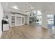 Spacious living area with wood floors, built-in shelving, and sliding doors to the pool at 1718 Sw 27Th St, Ocala, FL 34471