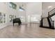 Expansive living room with soaring ceilings, grand staircase, piano, and abundant natural light at 1718 Sw 27Th St, Ocala, FL 34471