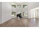 Spacious living room featuring high ceilings, a piano, and large windows offering outdoor views at 1718 Sw 27Th St, Ocala, FL 34471