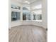 Large open room features corner window, wood floors, and view of outdoor living area at 1718 Sw 27Th St, Ocala, FL 34471