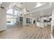Bright living area with wood floors leading to a screened pool area and waterfall feature at 1718 Sw 27Th St, Ocala, FL 34471