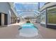 Screened-in pool with waterfall feature, multiple access points to the home, and spacious concrete pool deck at 1718 Sw 27Th St, Ocala, FL 34471