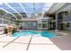 Beautifully enclosed pool area with a waterfall and large patio, offering a private and refreshing escape at 1718 Sw 27Th St, Ocala, FL 34471
