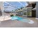 Private enclosed pool area with rock waterfall feature, creating a serene and luxurious outdoor space at 1718 Sw 27Th St, Ocala, FL 34471