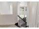Open staircase with wrought iron spindles overlooks the living room and piano at 1718 Sw 27Th St, Ocala, FL 34471