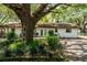Inviting backyard view of home with a big, shady tree and an outdoor seating area at 2161 Ne 38Th St, Ocala, FL 34479
