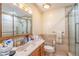 Neutral bathroom with a shower over the tub and a wooden vanity with sink at 2161 Ne 38Th St, Ocala, FL 34479