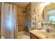 Inviting bathroom with tiled shower and bathtub combination, sink and vanity, with decorative fixtures at 2161 Ne 38Th St, Ocala, FL 34479
