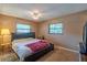 A bedroom with a comfortable bed, fan and two windows providing natural light at 2161 Ne 38Th St, Ocala, FL 34479