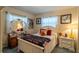 Bright bedroom enhanced by two windows dressed in white drapes and featuring decorative artwork at 2161 Ne 38Th St, Ocala, FL 34479