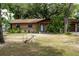 Charming single-story home with a well-manicured front yard, mature trees, and a cozy, inviting facade at 2161 Ne 38Th St, Ocala, FL 34479