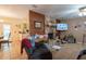 Cozy living room featuring a stone fireplace and view into kitchen at 2161 Ne 38Th St, Ocala, FL 34479