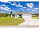 Beautiful one-story home with a two-car garage and a lush green lawn at 2329 Sw 143Rd Ct, Ocala, FL 34481