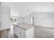 Open-concept kitchen with an island, modern lighting, and views of the living room at 2329 Sw 143Rd Ct, Ocala, FL 34481