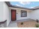 Inviting entryway showcases a red door and manicured landscaping, creating a warm welcome at 26 Water Track Dr, Ocala, FL 34472